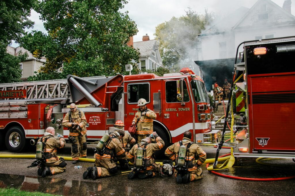 A fire truck is parked in front of a house, responding to an electrical emergency.